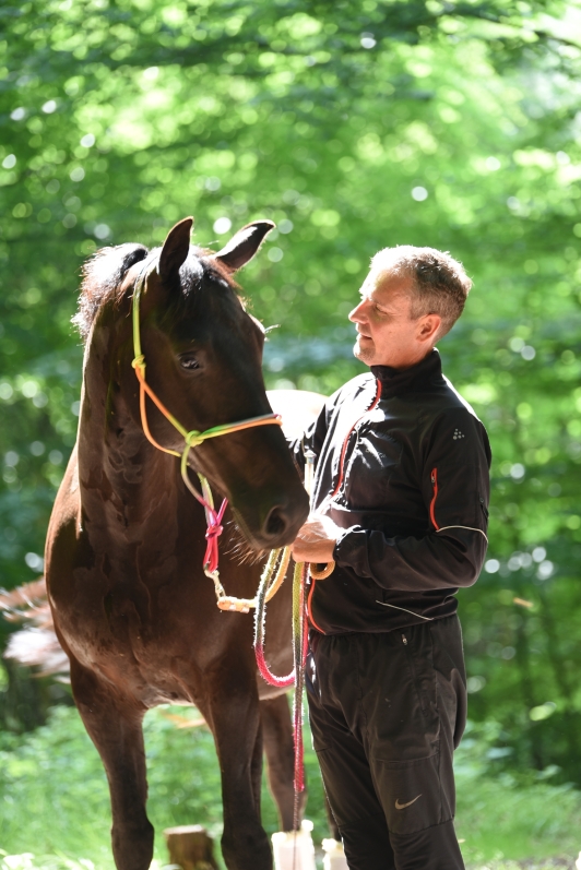 Claus with his horse in a forest setting